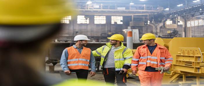 Workers walking and talking in factory